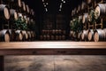 empty wooden table against the backdrop of a huge wine hangar Royalty Free Stock Photo