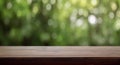 Empty wooden table against a blurred green nature background for product display Royalty Free Stock Photo