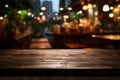 Empty wooden table against a blurred restaurant backdrop for product mock ups