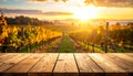Empty wooden table against a vibrant sunset over rolling vineyard hills foreground Royalty Free Stock Photo
