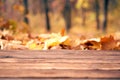 Empty wooden table autumn leaves nature bokeh background with a country outdoor theme,Template mock up for display of product Royalty Free Stock Photo