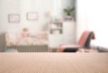 Empty wooden table in baby room