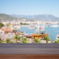 Empty wooden table. In the background blurred boats and yachts