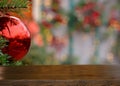 Empty wooden table on the background of a Christmas branch with red ball and golden bokeh. Christmas background.Ready for product Royalty Free Stock Photo