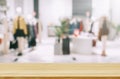 Empty brown wooden table and De focused,blurry background of clothing store with bokeh image luxury and fashionable brand Royalty Free Stock Photo