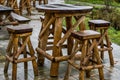 Empty wooden table with bar crutches, garden or terrace furniture, rainy day in the catering industry Royalty Free Stock Photo