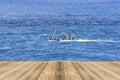 Empty wooden table and Beautiful calm blue sea with boat, Tranquil sea harmony of calm water surface