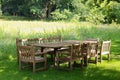 Empty wooden table with bench and chairs in garden Royalty Free Stock Photo