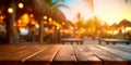 Empty wooden table and blurred background of beach cafe with bokeh lights Royalty Free Stock Photo