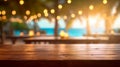 Empty wooden table and blurred background of beach cafe with bokeh lights Royalty Free Stock Photo