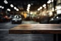 Empty wooden table and blurred background of car showroom with bokeh lights, product display montage