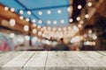 Empty wooden table and blurred background at night market festival people walking on road with copy space, display montage for Royalty Free Stock Photo
