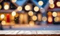 Empty wooden table, blurred Christmas decorated house exterior Royalty Free Stock Photo