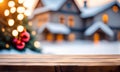 Empty wooden table, blurred Christmas decorated house exterior Royalty Free Stock Photo