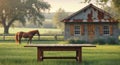 Empty Wooden Table with Blurred Farm Background featuring Horse and Cabin in a Field Royalty Free Stock Photo