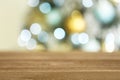 Empty wooden table and blurred fir tree with Christmas lights on background, bokeh effect Royalty Free Stock Photo