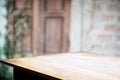 Empty wooden table with blurred outdoor garden background