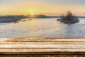 Empty wooden table with blurred picteresque winter background