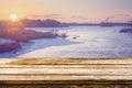 Empty wooden table with blurred picteresque winter background