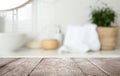 Empty wooden table and blurred view of bathroom interior Royalty Free Stock Photo