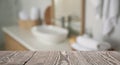 Empty wooden table and blurred view of bathroom interior Royalty Free Stock Photo