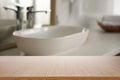 Empty wooden table and blurred view of bathroom interior Royalty Free Stock Photo