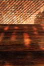 Empty Wooden Table with Brick Wall and Sunlight Shadow Royalty Free Stock Photo