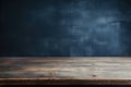 empty wooden table with dark blue grunge wall in the background Royalty Free Stock Photo