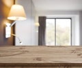 Empty wooden table on defocused simple hotel room interior background Royalty Free Stock Photo