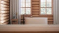 Empty wooden table, desk or shelf with blurred view of log cabin bathroom with bathtub and windows, rustic vintage interior design Royalty Free Stock Photo