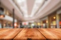 Empty wooden table in front of abstract blurred background of shopping mall Royalty Free Stock Photo