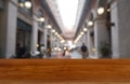 Empty wooden table in front of abstract blurred background of shopping mall and people . can be used for display or montage your Royalty Free Stock Photo