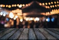 Empty wooden table in front of abstract blurred festive background with light spots and bokeh for product montage display of prod