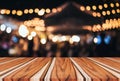 Empty wooden table in front of abstract blurred festive background with light spots and bokeh for product montage display of prod Royalty Free Stock Photo