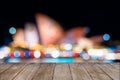 Empty wooden table in front of blurred unidentifiable blurred Sydney Opera House in background