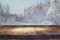 Empty wooden table in front of magical winter landscape