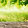 Empty Wooden Table in the Garden with Bright Green Background Royalty Free Stock Photo