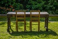 Empty wooden table with garden and two chairs for food. Outdoor Royalty Free Stock Photo