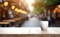 Empty wooden table with glass and Coffee shop blur background with bokeh image. Royalty Free Stock Photo