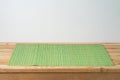 Empty  wooden table with green bamboo placemat. Chinese kitchen or restautant concept background Royalty Free Stock Photo