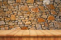 Empty wooden table and old stone wall background Royalty Free Stock Photo