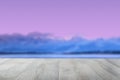 Empty wooden table over abstract blurred evening or sunset mood background texture with blue ocean and blue clouds with pink sunny Royalty Free Stock Photo