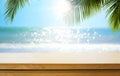 Empty wooden table over blurred sunny tropical beach background. Outdoor party mock up for design and product display Royalty Free Stock Photo