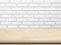 Empty wooden table over white brick wall. Royalty Free Stock Photo