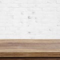 Empty wooden table over white brick wall background, for produc Royalty Free Stock Photo