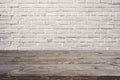 Empty wooden table over white brick wall. Background for product montage Royalty Free Stock Photo