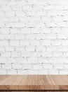 Empty wooden table over white brick wall background Royalty Free Stock Photo