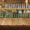 Empty wooden table over wine store background Royalty Free Stock Photo