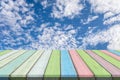 Empty wooden table or plank with blue sky and cloud background for product display. Royalty Free Stock Photo