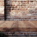 Empty wooden table for product display montages with vintage brick wall background Royalty Free Stock Photo